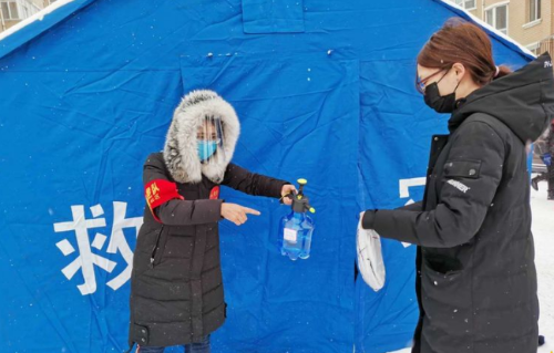 铁选厂党支部书记邱菊在为社区居民邮件消毒。。。。。。。。